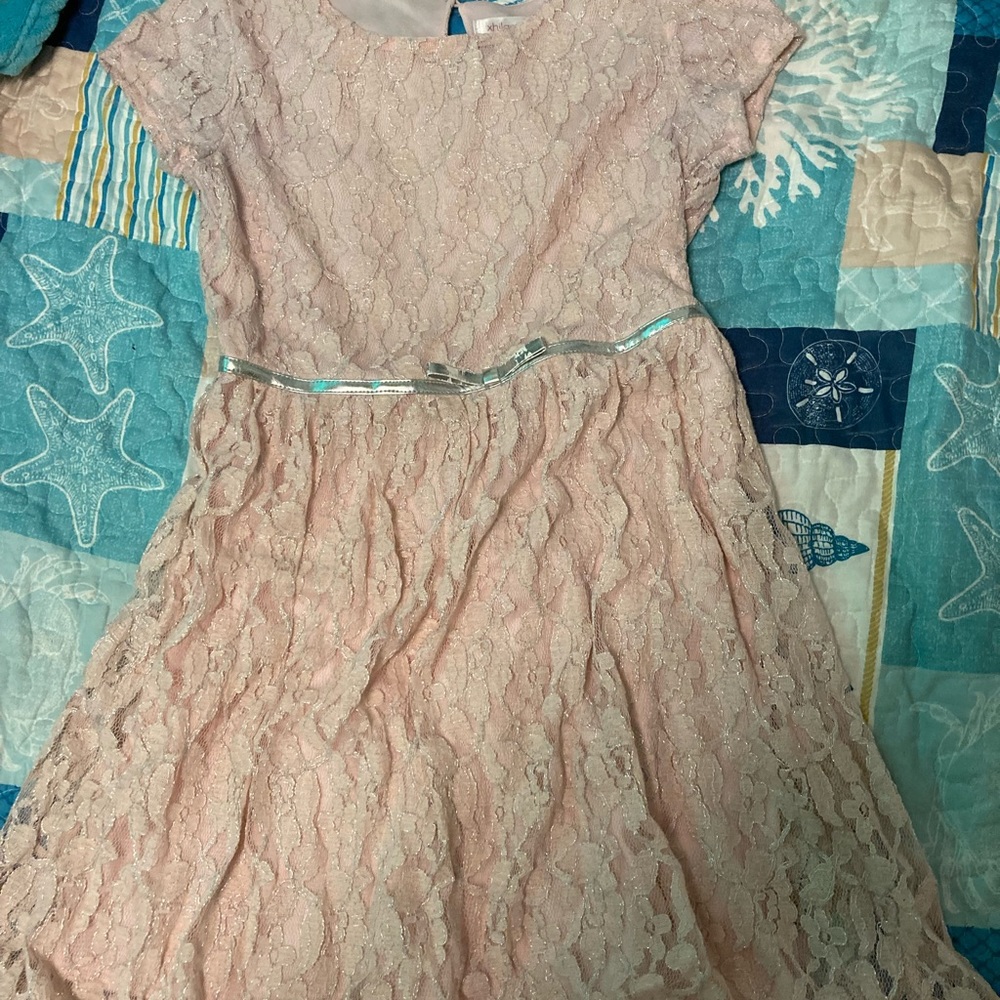 This is a beautiful pink,lacy,bowed dress for kids